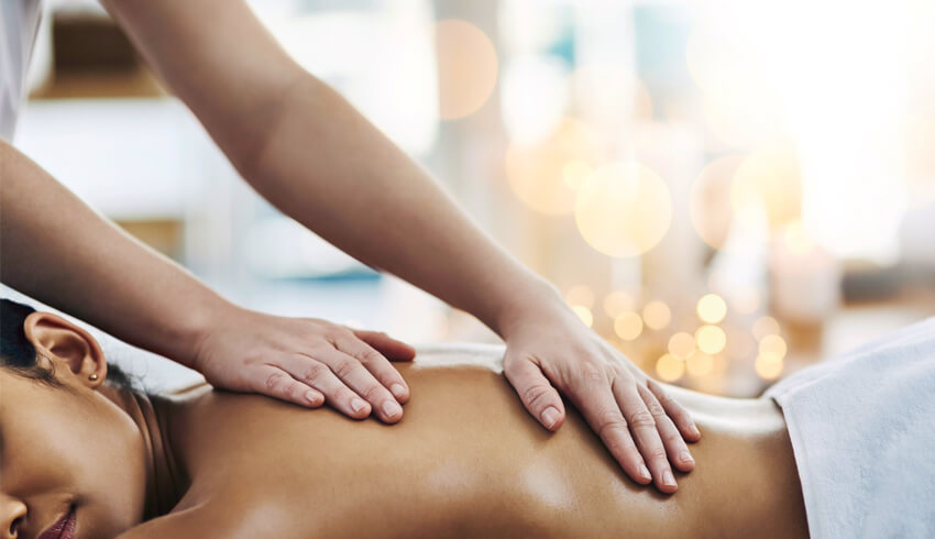 A woman receiving a massage at a spa